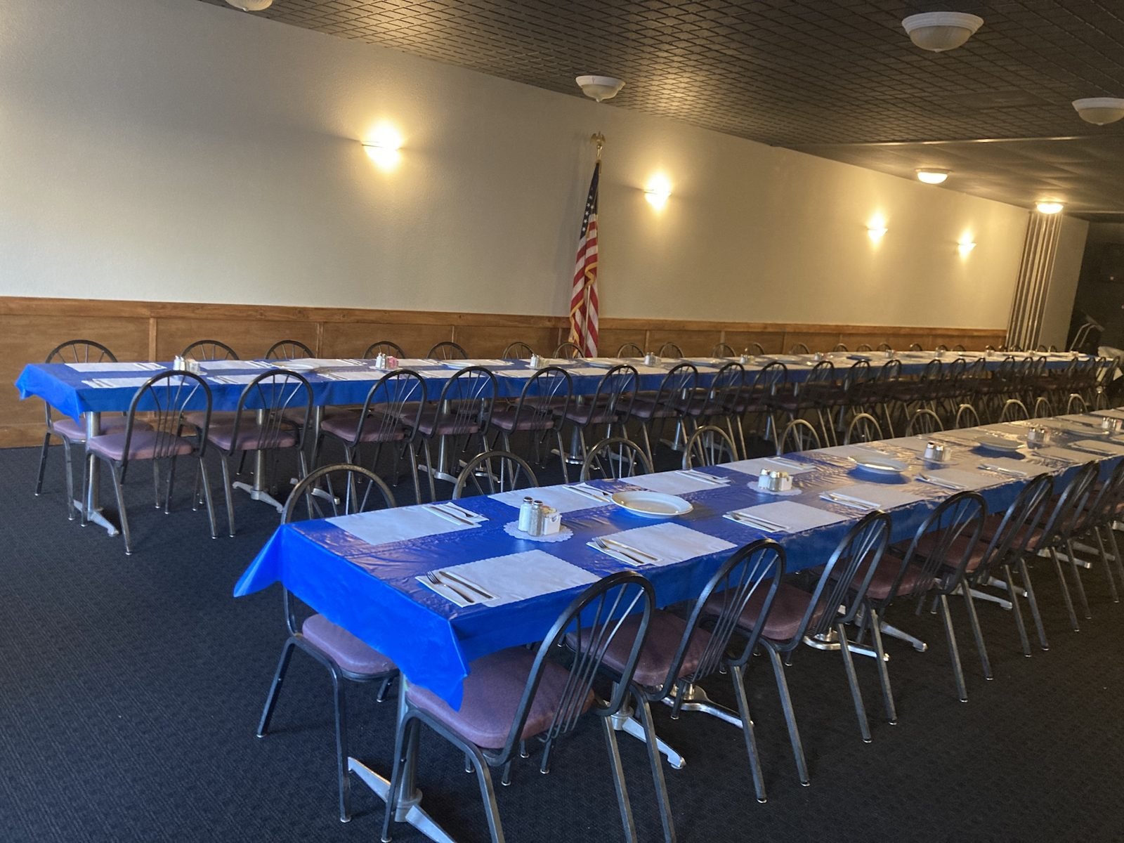 The banquet room at M&M set with long tables for a party