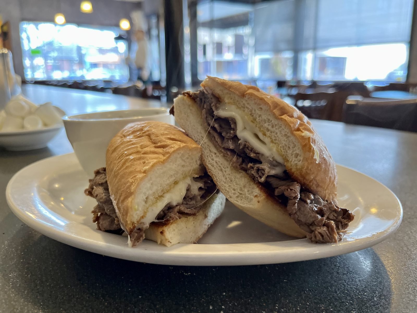 French dip sandwich with Swiss on a hoagie bun